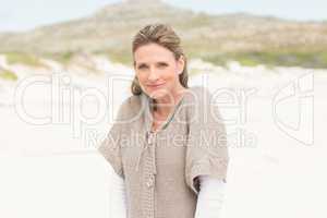 Smiling woman standing on the sand