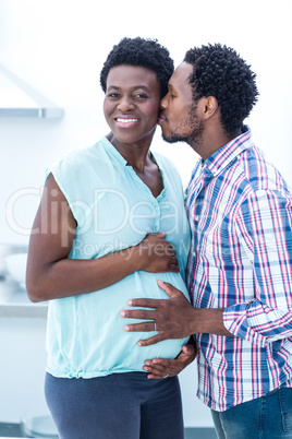 Man kissing his pregnant wife