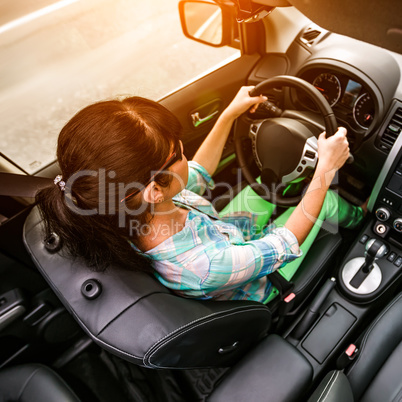 Woman behind the wheel of a car.