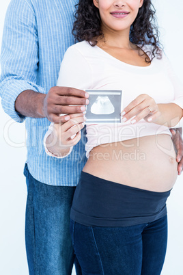 Midsection of couple with sonogram