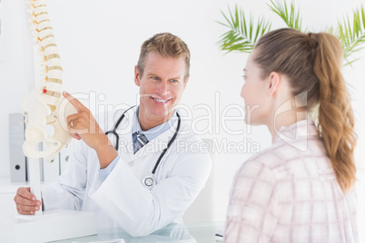 Doctor explaining anatomical spine to his patient