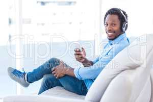 Portrait of smiling man listening to music