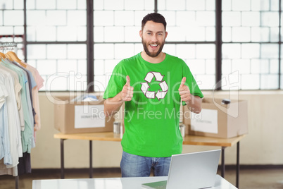 Portrait of happy man in recycling symbol tshirt showing thumbs