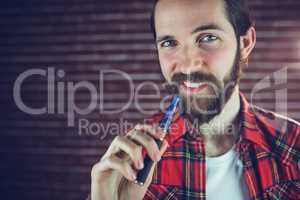 Portrait of smiling man with electronic cigarette
