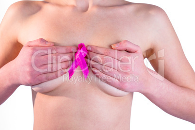 Nude woman with breast cancer ribbon