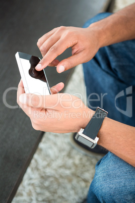 High angle view of man scrolling on mobile phone