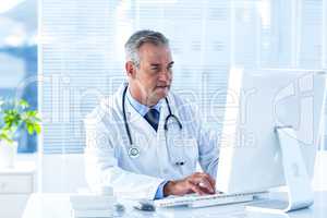 Male doctor using computer in hospital