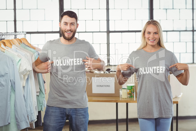 Portrait of volunteers showing volunteer text on tshirts