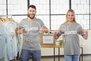 Portrait of volunteers showing volunteer text on tshirts