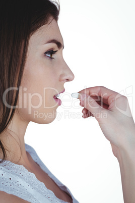 Pretty woman taking white pill