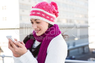 Smiling woman using her smartphone