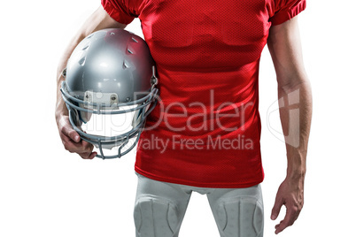 American football player holding helmet aside