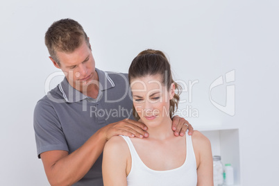 Doctor examining his patient neck