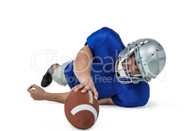 American football player struggling to catch the ball