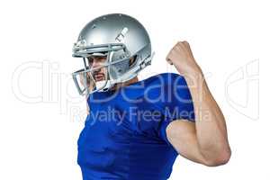 Confident American football player flexing muscles