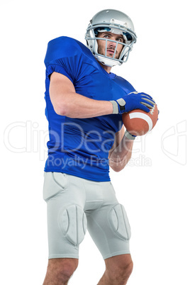 Confident American football player throwing the ball