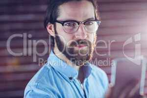 Confident hipster looking at cellphone