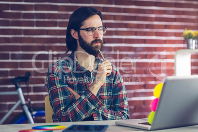 Thoughtful businesman with laptop