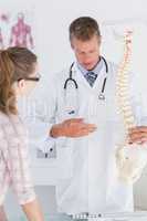 Doctor explaining the spine to his patient