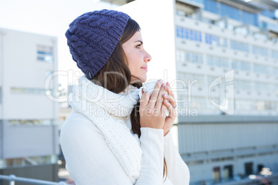 Brunette with warm clothes holding mug