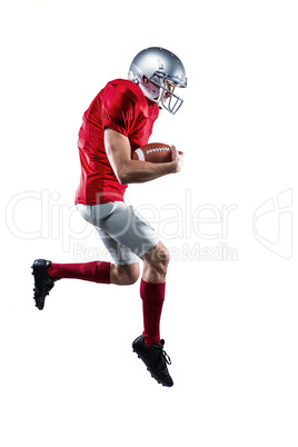 American football player holding ball while running