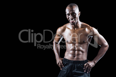 Portrait of happy muscular man with hand on hip Portrait of happy muscular man with hand on hip