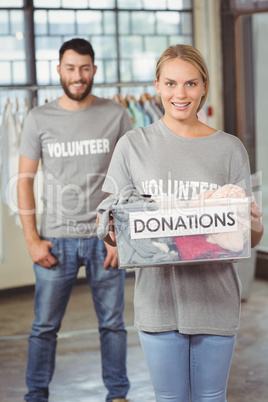 Volunteer holding clothes donation box