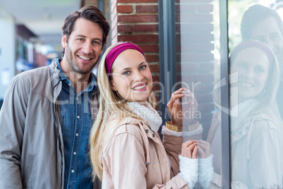 Smiling couple going window shopping
