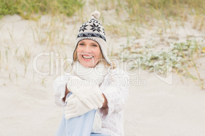 Woman sitting down on the sand