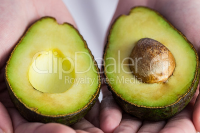 Woman showing fresh avocado