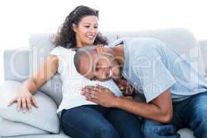 Man listening to pregnant woman belly