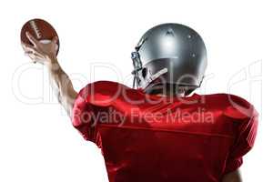Rear view of American football player in red jersey holding ball
