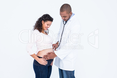 Smiling doctor examining pregnant woman