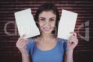 Pretty brunette holding two pages