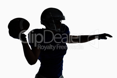 Silhouette American football player throwing ball