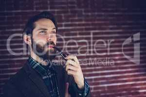 Handsome man smoking pipe