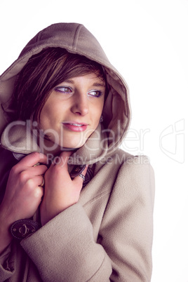 Attractive woman wearing a warm coat with hood raised