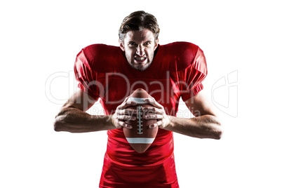 Angry American football player in red jersey holding ball