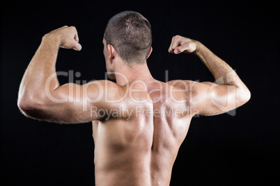 Shirtless athlete flexing muscles