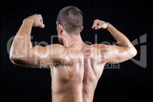 Shirtless athlete flexing muscles
