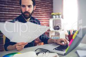 Confident creative businessman reading documents