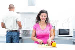 Portrait of happy wife chopping vegetables