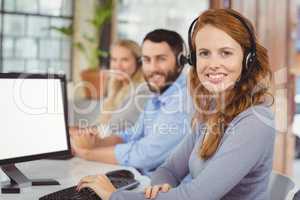 Portrait of smiling operators working in office