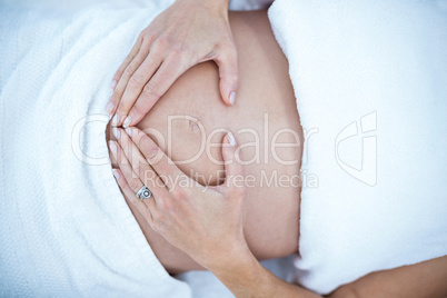 Pregnant woman touching her belly