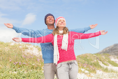 Smiling couple with arms wide open