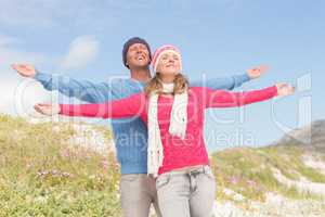 Smiling couple with arms wide open