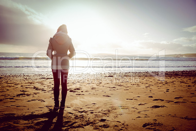 Rear view of woman looking at the sea during the sunset