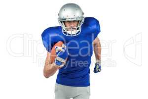 Confident American football player running with ball