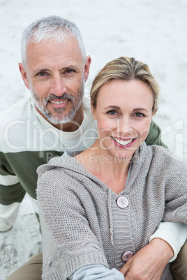 Cute couple sitting in the sand