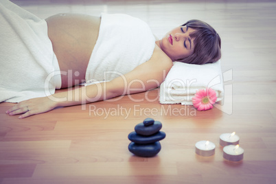 Pregnant woman relaxing on hardwood floor